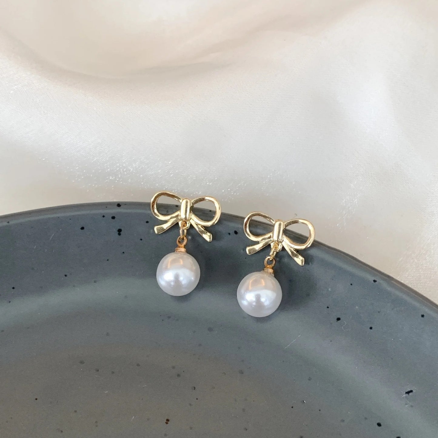 Gold Bow with Dangling Simulated Pearls Clip On Stud Earrings