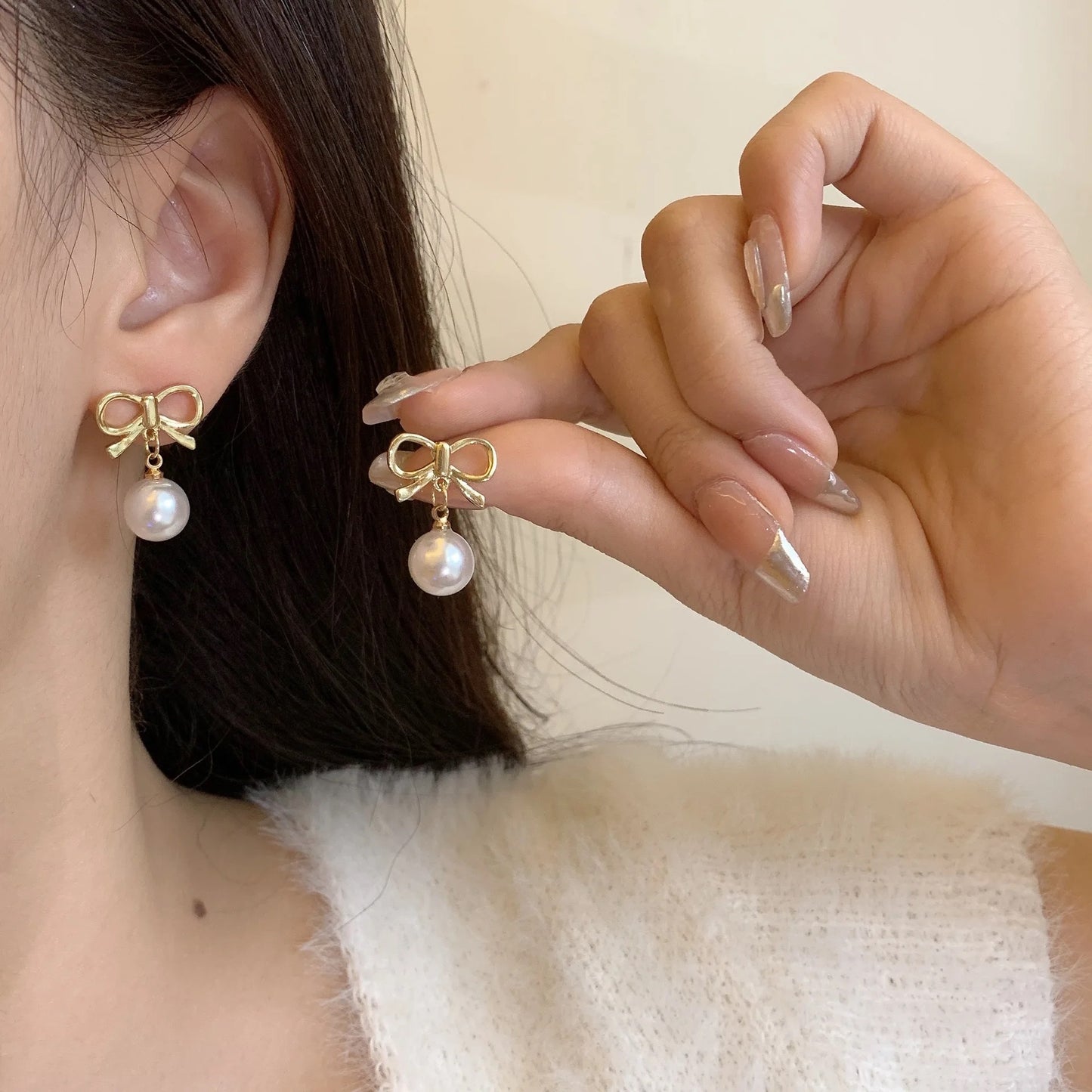 Gold Bow with Dangling Simulated Pearls Clip On Stud Earrings